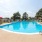 pool area with reclining seats and landscaping