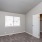 bedroom with a large window and a closet