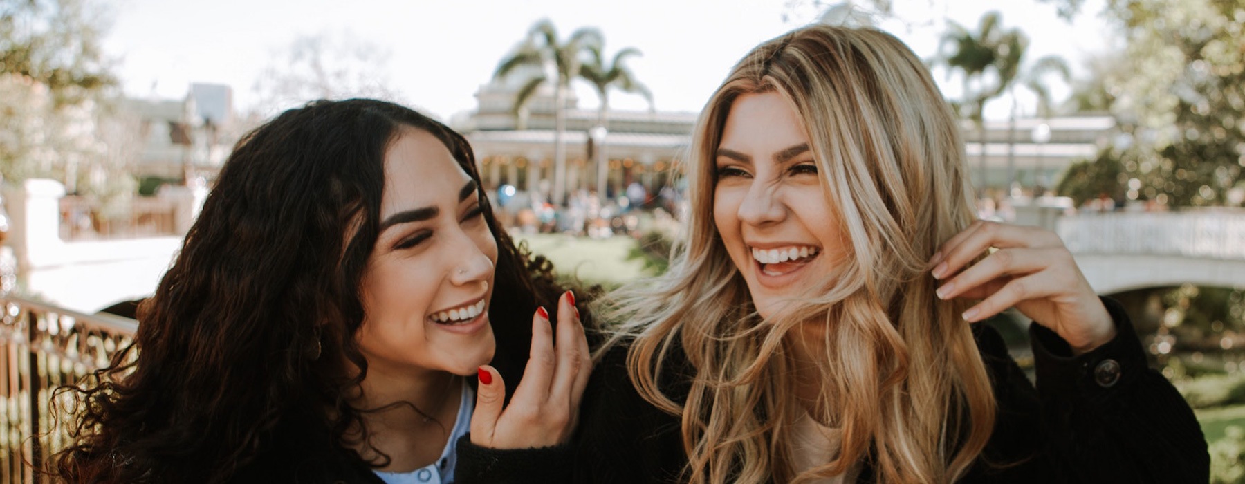 lifestyle image of two young women smiling outdoors